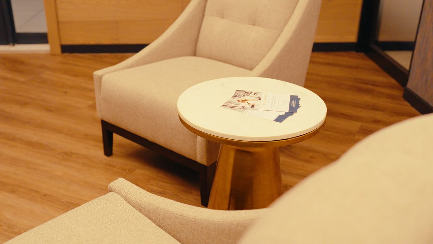 Client lounge at The Gold Avenue gold exchange, Illovo Point, Sandton, with upholstered armchairs and a marble table