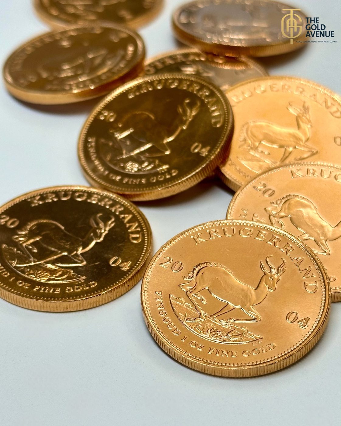 Several one ounce fine gold Krugerrand coins showing the springbok reverse, at The Gold Avenue in Illovo, Sandton